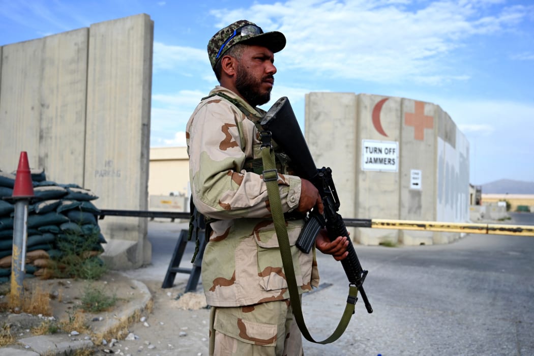 An Afghan National Army (ANA) soldier stands guard at the gate of a hospital inside the Bagram US air base after all US and NATO troops left, 5 July 2021.