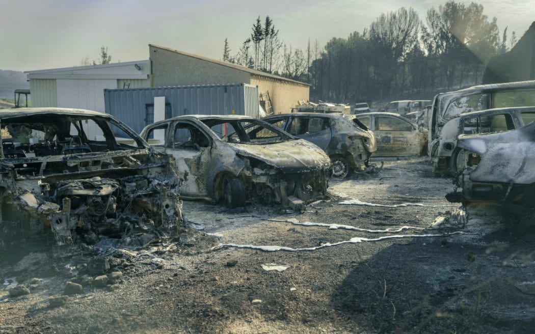Burnt vehicles are seen due to a wildfire that broke out in Saint-Laurent-de-la-Cabrerisse, southwestern France, on August 6, 2025.
