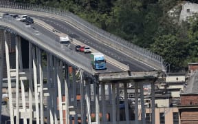 Vehicles on the Morandi motorway bridge the day after a section collapsed in the north-western Italian city of Genoa.