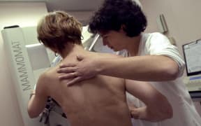 A woman having a mammogram.