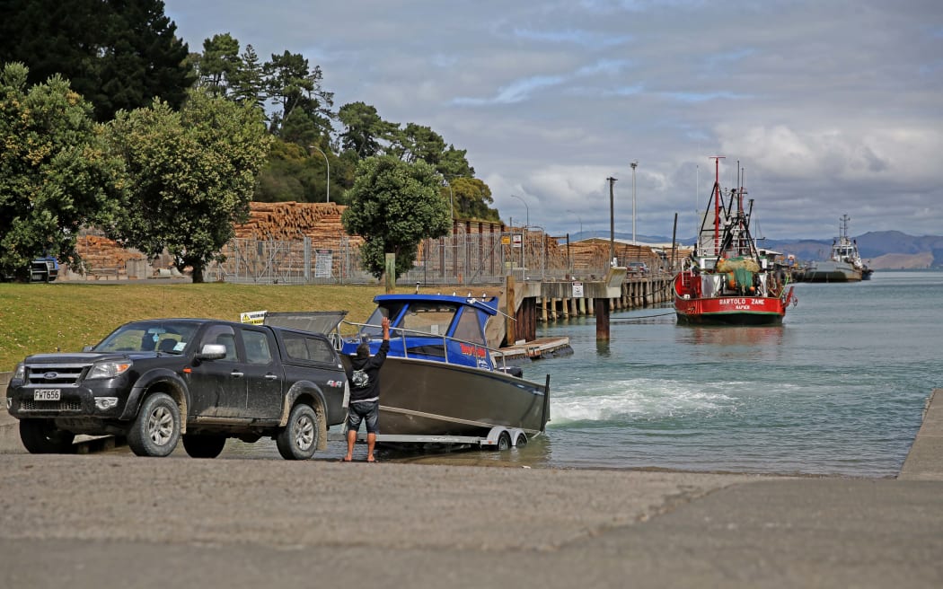 Calling it a day as fishermen bring their boat into the port of Gisborne.