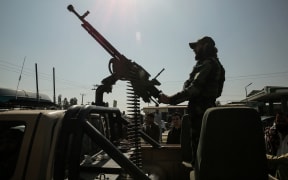 A Taliban security personnel rides an armed vehicle on the outskirts of Jalalabad on February 28, 2026, amid the ongoing clashes between Pakistan and Afghanistan. Afghanistan said it downed a Pakistan fighter jet and captured its pilot on February 28, a claim denied by Islamabad a day after it declared an "open war" with its South Asian neighbour. (Photo by AFP)