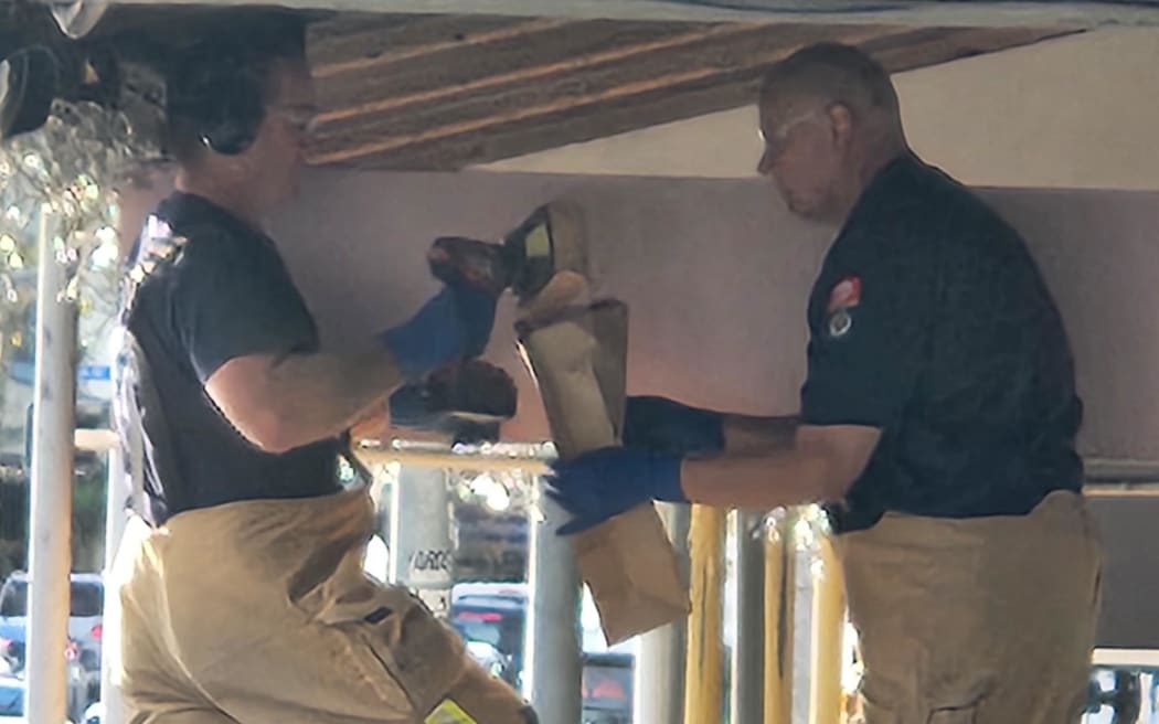 FENZ staff investigate the ceiling above the scene of Sunday night's Ponsonby Road shooting on 6 May 2024.