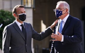 French President Emmanuel Macron greets Australian Prime Minister Scott Morrison at the Elysee Palace in Paris on 15 June, 2021.