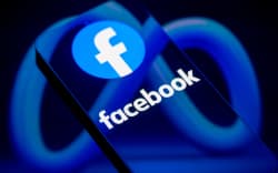 The Facebook logo is displayed on a smartphone screen in this photo illustration in Brussels, Belgium, on March 29, 2026. Meta Platforms expands its AI services while facing regulatory pressure in Europe over data use, competition rules, and access to rival AI tools. (Photo by Jonathan Raa/NurPhoto) (Photo by Jonathan Raa / NurPhoto via AFP)