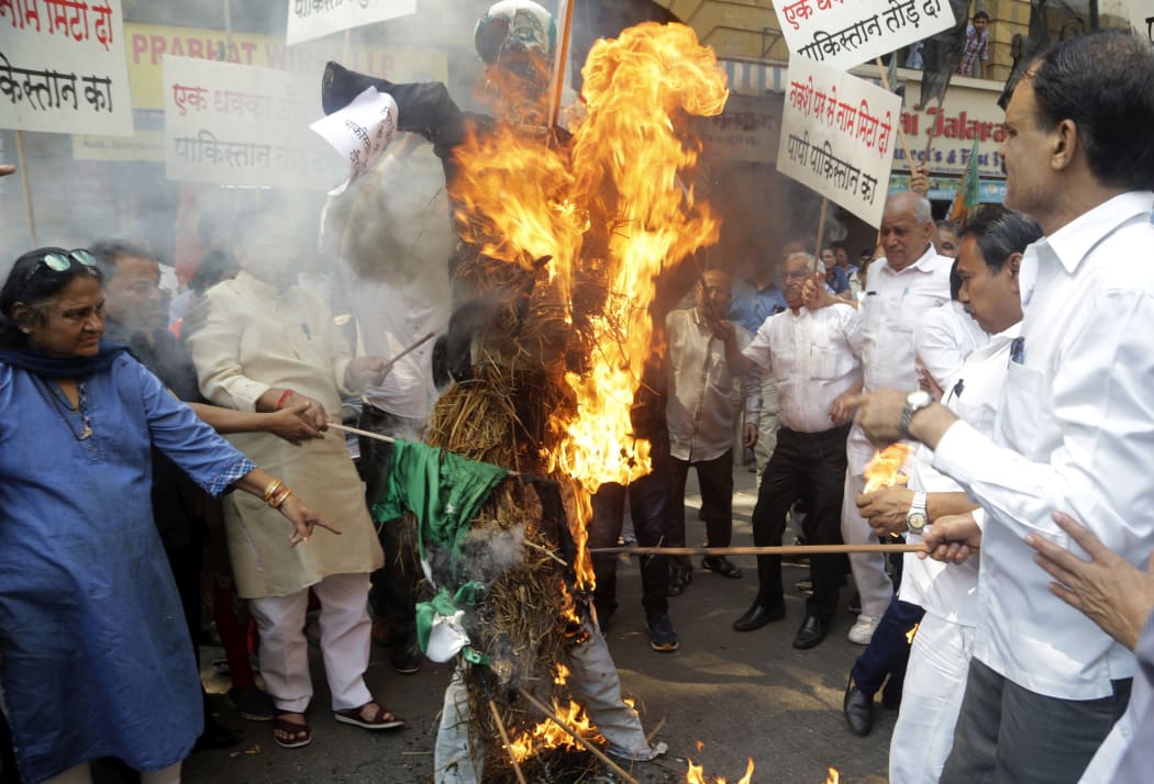 India's ruling Bharatiya Janata Party workers burn a symbolic effigy of Pakistan as part of protest against Thursday's attack on a paramilitary convoy in Kashmir.
