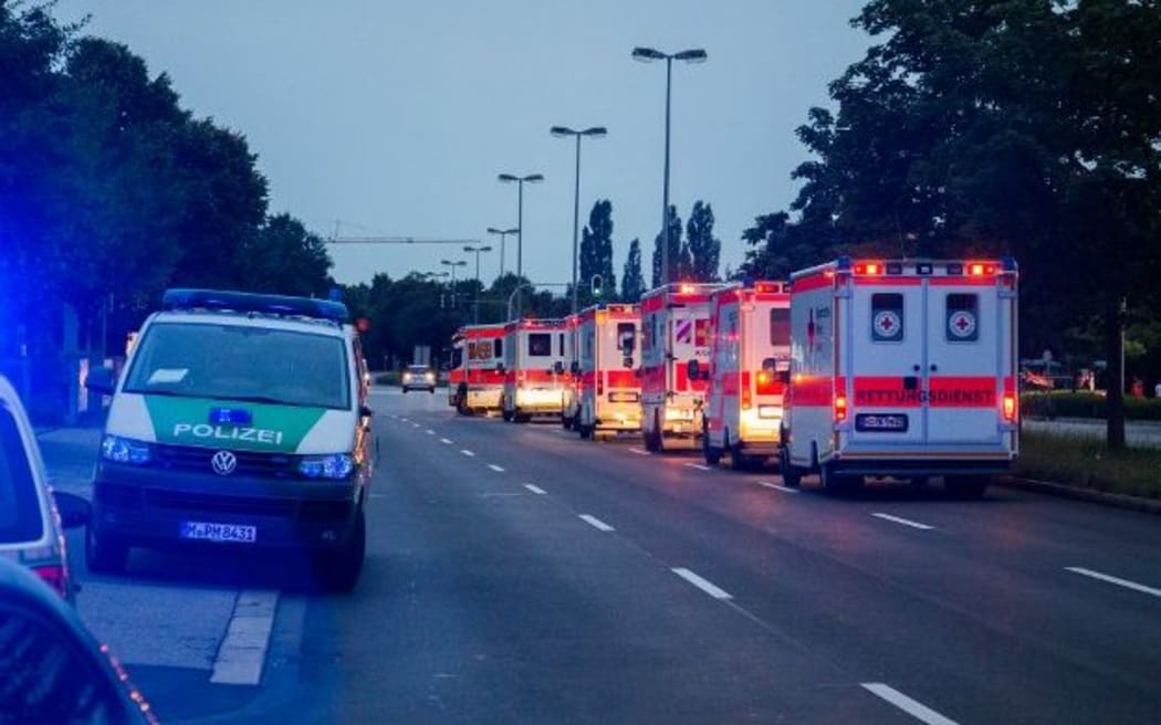 Police cars and ambulances are seen near the shopping mall in Munich following the shootings.
