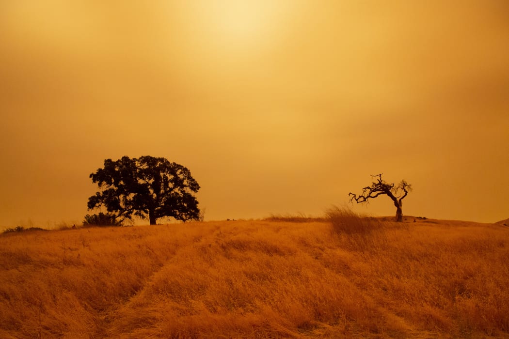 An orange sky filled with wildfire smoke hangs above hiking trails at the Limeridge Open Space in Concord, California, on 9 September, 2020.
