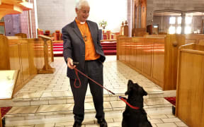 Dean Mike Hawke and Paddy the labrador practises being blessed at Nelson Cathedral