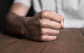 Man's fist suggesting violence or crime