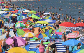People crowd the beach at Zinnowitz on the island of Usedom in the Baltic Sea, northern Germany.