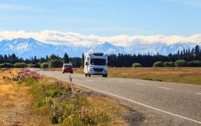Family vacation trip, leisurely travel in motor home, Happy Holiday Vacation in Caravan camping car. Beautiful Nature New Zealand natural landscape Scenic route with camper van in New Zealand.