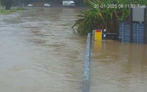 A Northland Regional Council webcam image shows a flooded Kāeo River just centimetres from State Highway 10 at 8am Tuesday 21 January.