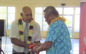 The Reverend Apineru Lafai (left) hands keys over to the Minister of Sports Loau Keneti Sio