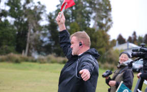 Gary MacRae as touch judge for the Woodham Shield final