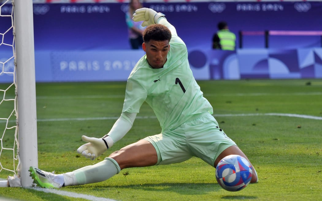 All Whites goal keeper Alex Paulsen makes a save during the Paris Olympics 2024 Football game between All Whites vs Guinea.