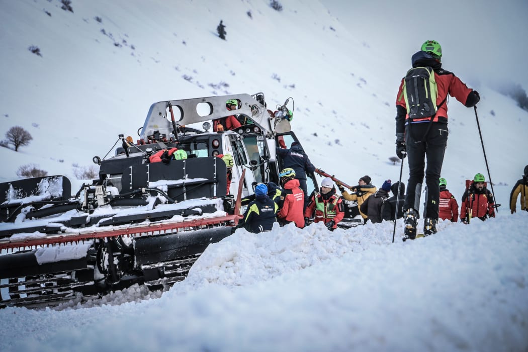 Rescuers work at the crash site in the mountains, near the ski resort of Campo Felice, central Italy.