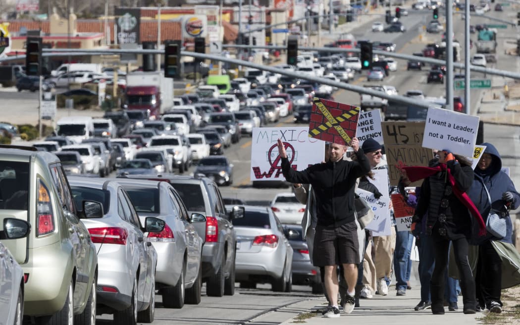 Protesters turn out in Victorville, California., Monday, Feb. 18, 2019, to protest President Donald Trump's declaration of national emergency to build a southern border wall.