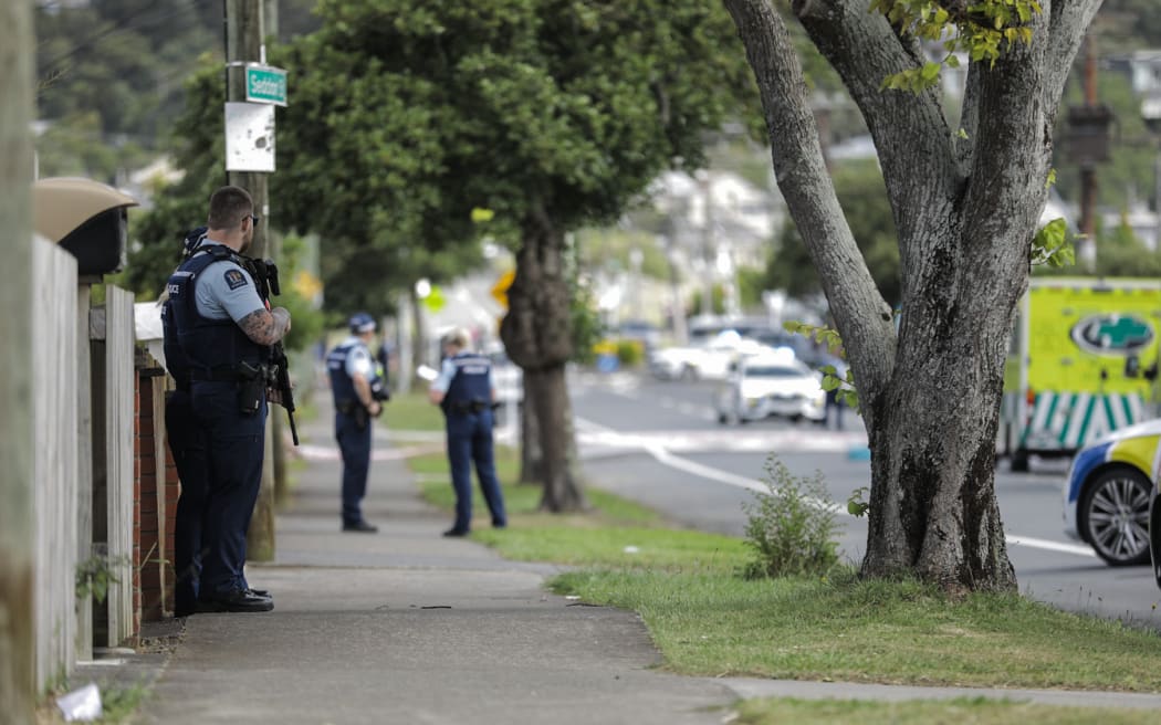 Multiple police cars and ambulances are on the street.