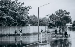 Napier flood - people walking, children bikes, playing in water