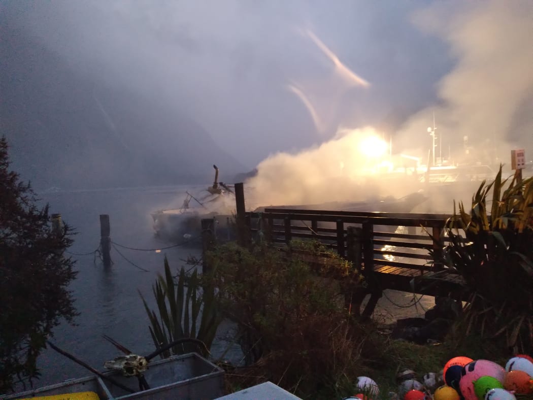 Fire on a boat in Deep Water Basin, Milford Sound