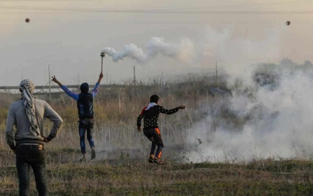 A Palestinian protester hurls a rock at Israeli forces during clashes near the Israel-Gaza border east of Gaza City.