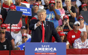 Former President Donald Trump points at the press box speaks of "Fake News" during his campaign-style rally in Wellington, Ohio, on 26 June 2021.