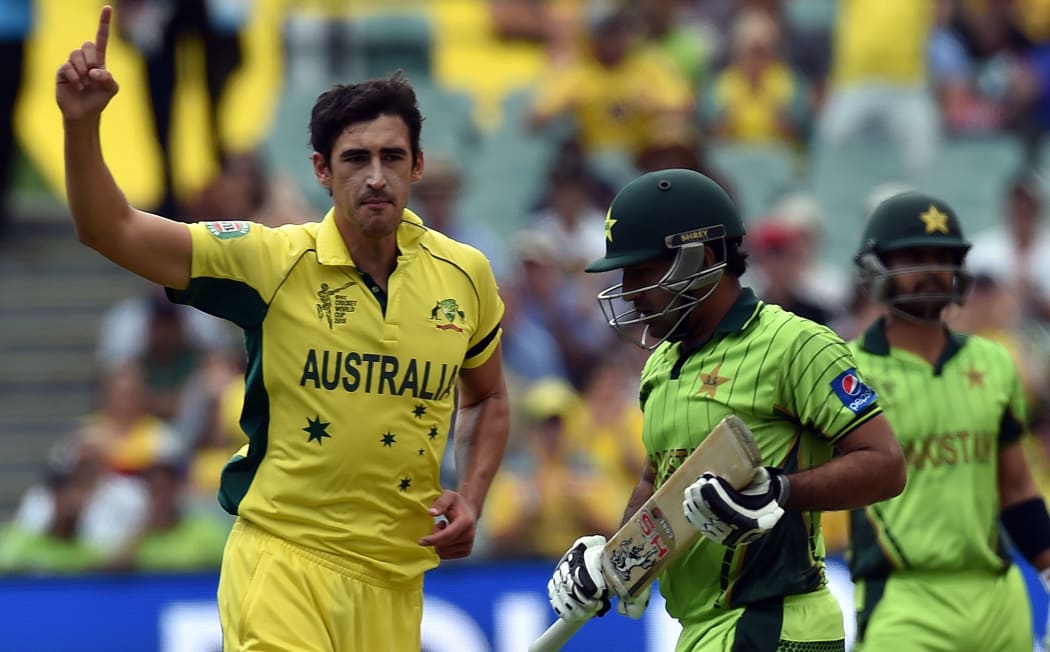 Pakistan's batsman Sarfraz Ahmed (C) walks off the field as Australia's paceman Mitchell Starc (L) celebrates his dismissal.