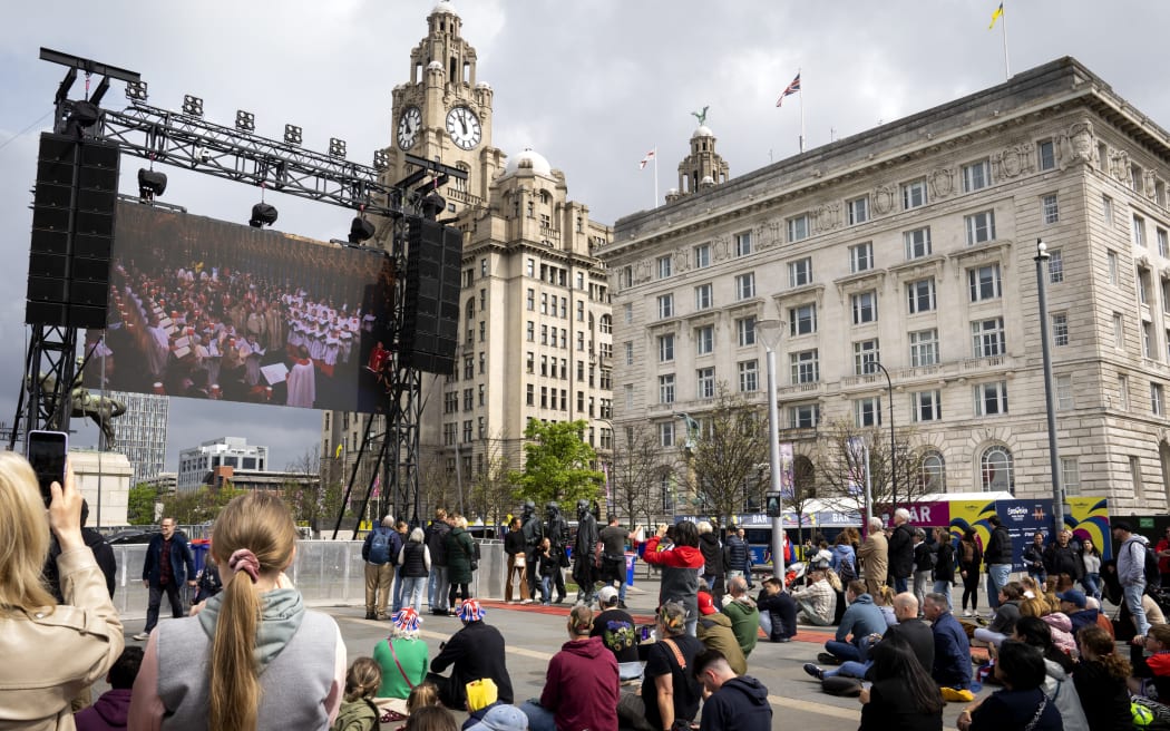 LIVERPOOL - The coronation of Charles can be seen on large screens in the Eurovision Village (fan zone of the Eurovision song contest). Charles has been officially king since the death of his mother Elizabeth, but the coronation was still a long time coming. ANP SANDER KONING netherlands out - belgium out (Photo by Sander KONING / ANP MAG / ANP via AFP)