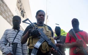Armed gang leader Jimmy "Barbecue" Cherizier and his men are seen in Port-au-Prince, Haiti, 5 March, 2024.