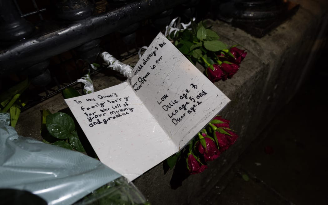 Floral tributes and cards placed on the gates of Buckingham Palace by members of the public following the announcement of the death of Queen Elizabeth II in London, United Kingdom on September 08, 2022.