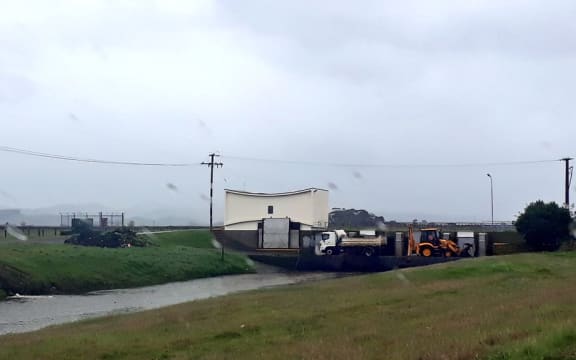 Council workers keeping one of Napier's main stormwater drains clear where it enters Pandora Estuary