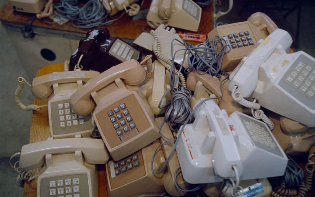 Discarded telephones litter an office desk in February 1996, in Manchester, New Hampshire.