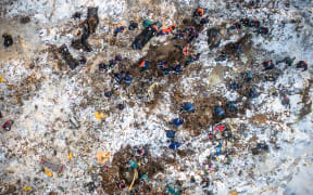 Emergency rescuers working at the site of the plane crash search through deep snow after the Russian passenger plane crashed in the Ramensky district near Moscow.