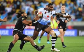 Fiji's Suliasi Vunivalu (R) is tackled by New Zealand's captain Adam Blair during the quarter-final.