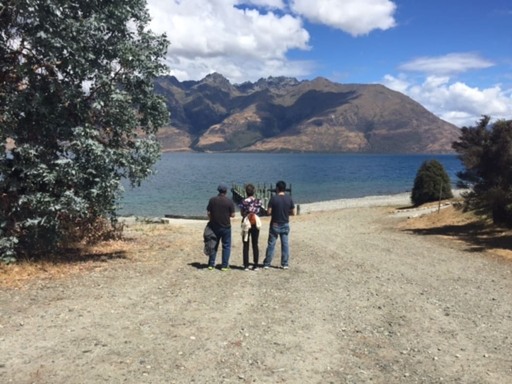 Tyler Nii’s parents and brother looking out over Lake Wakatipu.