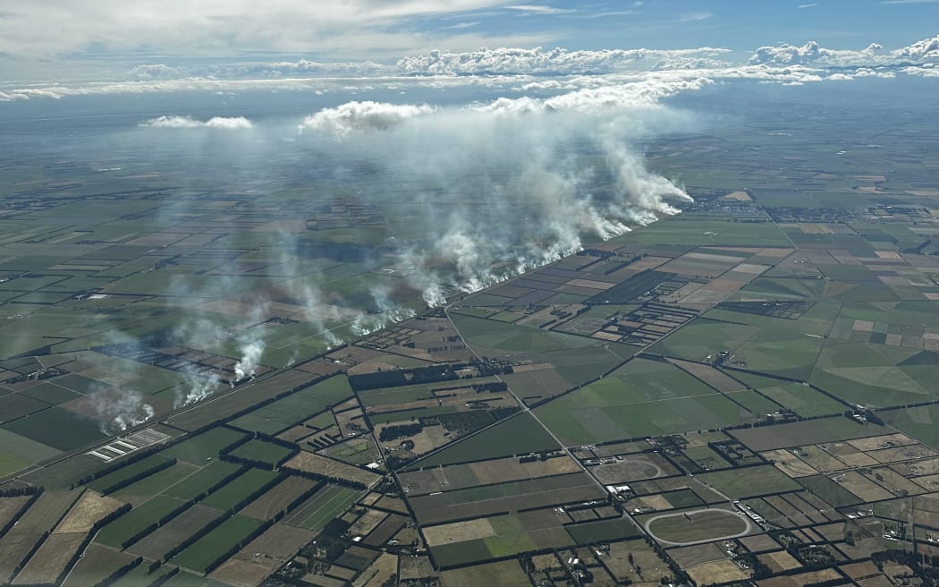 An aerial photo taken about 4.30pm Sunday as fires flared up along a Canterbury rail line.