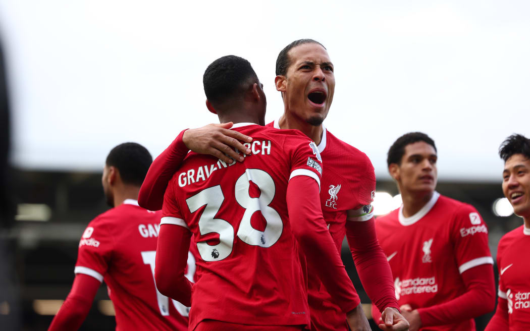 Liverpool celebrate a goal to defender Virgil van Dijk (C).