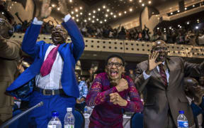 Members of Zimbabwe's parliament celebrate after Mr Mugabe's resignation.