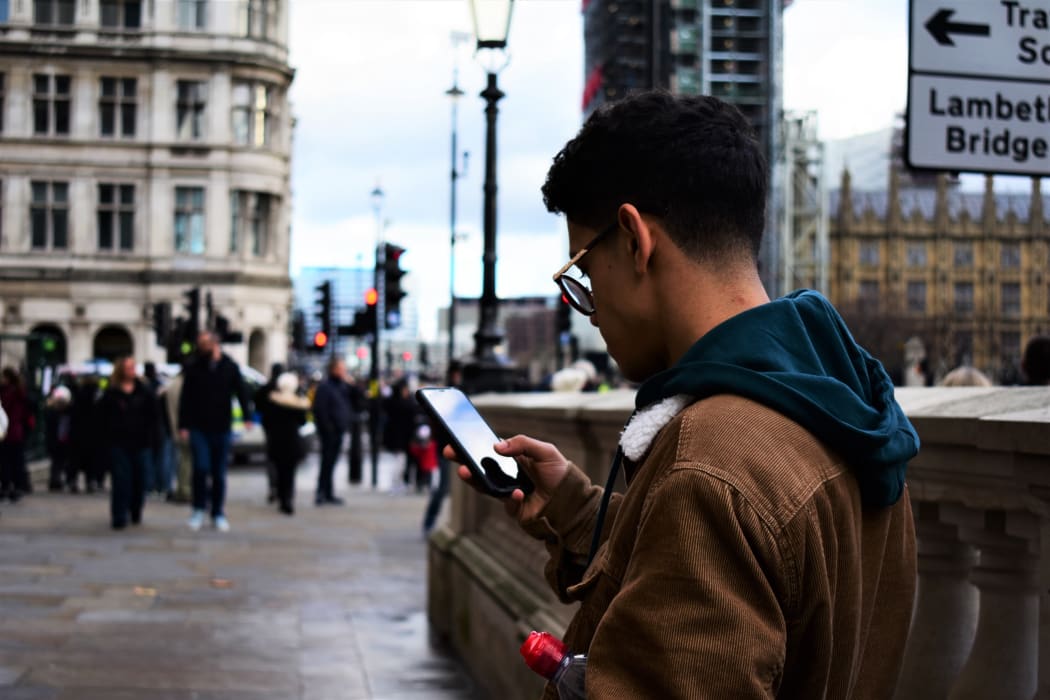 pedestrian smartphone footpath street