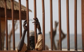 A parent waits outside the Government Science Secondary school in Kankara, in northwestern Katsina State, Nigeria on December 16, 2020.