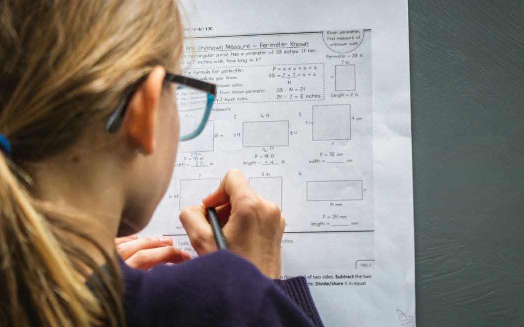 A child working on maths problems at school.