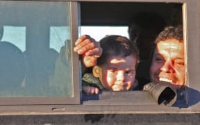 Syrians evacuated from rebel-held neighbourhoods in Aleppo  arrive in the opposition-controlled Khan al-Aassal region, west of the city, on 15 December. Civilians will be taken to  temporary camps on the outskirts of Idlib and the wounded to field hospitals.