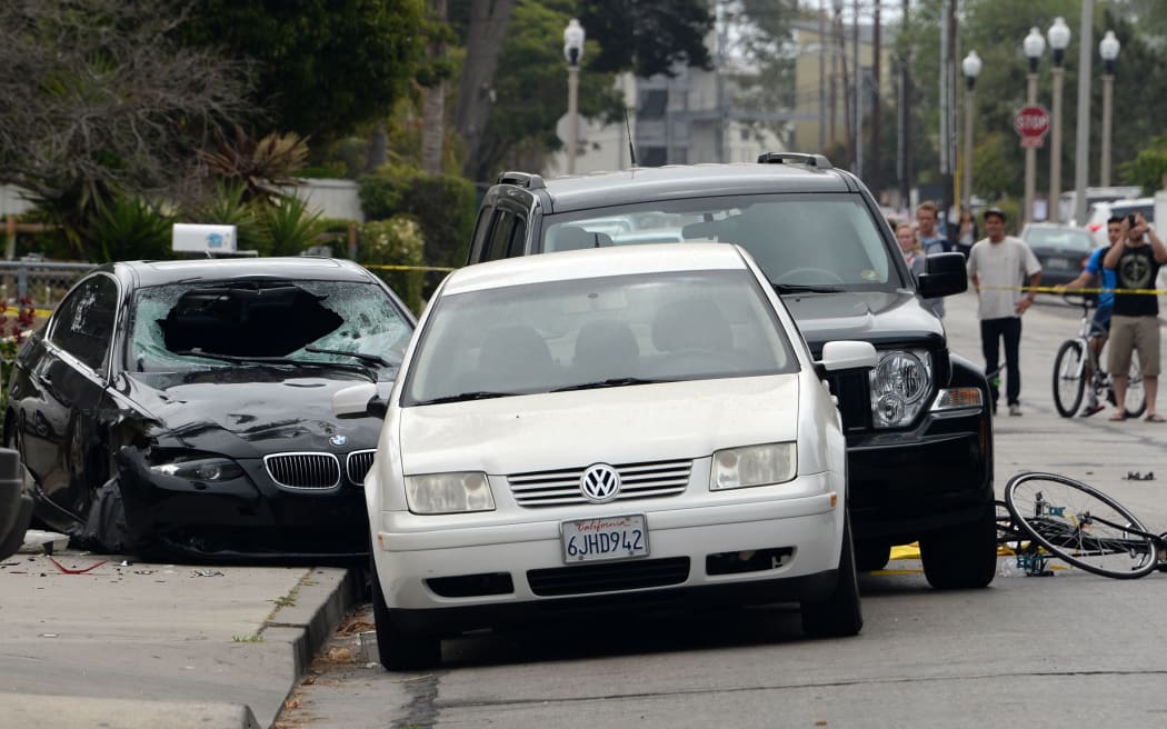 The crashed car (left) believed to have been driven by the gunman.