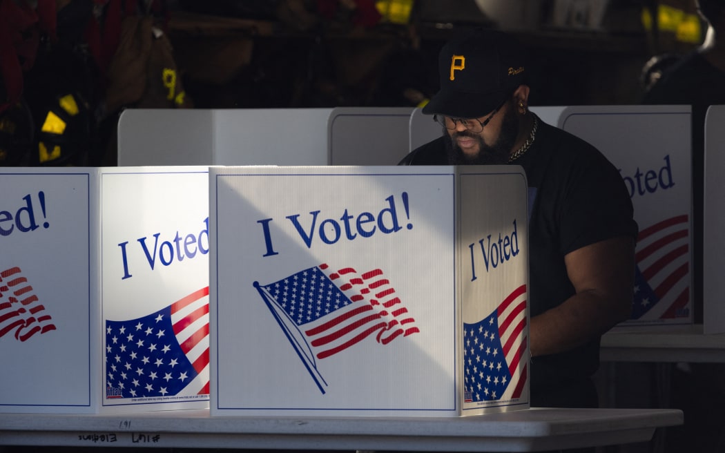 Michael Jones casts his ballot at a polling location inside Pittsburgh Bureau of Fire Engine Company #15 house in the Lincoln-Lemington-Belmar neighborhood of Pittsburgh, Pennsylvania, November 5, 2024. (Photo by Rebecca DROKE / AFP)