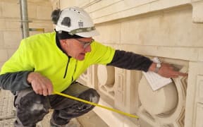 Mark Whyte examining an example of a 'banker' stonework on the Sarjeant Gallery facade, September 2023.