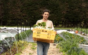 Jon with a box of newly harvested vegetables