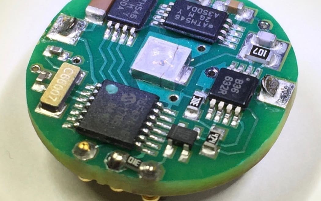 A close up of a circuit board on the back of a UV dosimeter.
