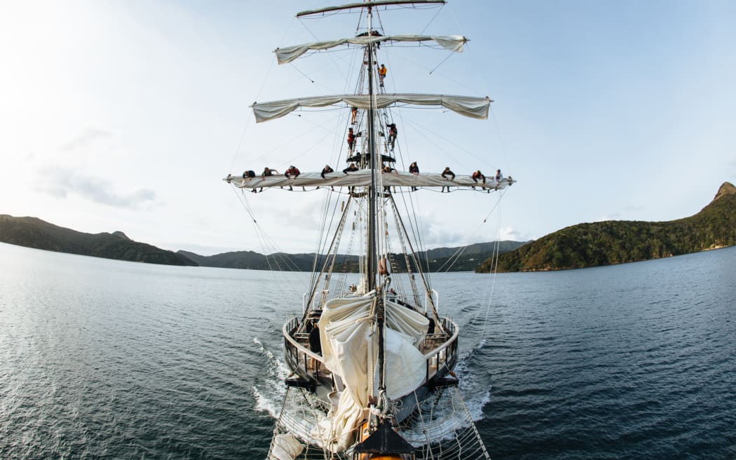 The Spirit of Adventure ship with trainees on the sails.