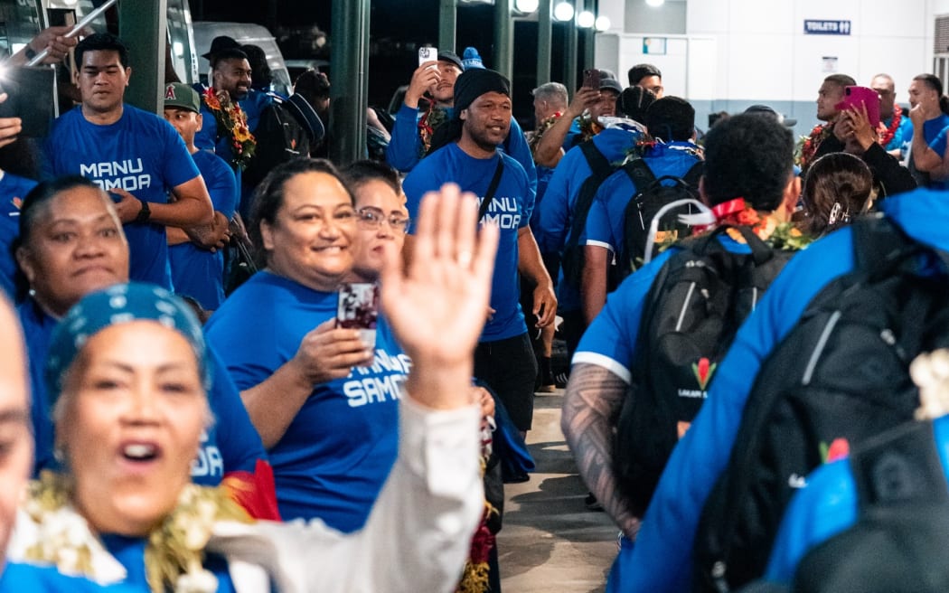 Manu Samoa fans in Tonga greet the team as they arrived at Fua'amotu airport on Monday. Photo: LAKAPI SAMOA